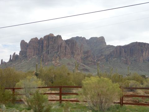 1995 Ford Bronco - A desert landscape mountains and saguaro cacti, viewed from a moving vehicle.
