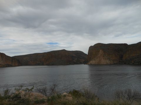 1995 Ford Bronco - A wide shot of a lake surrounded by hills under a cloudy sky.