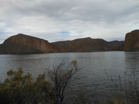 1995 Ford Bronco - A scenic view of a lake surrounded by mountains under a cloudy sky.