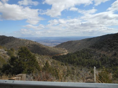 1995 Ford Bronco - A scenic view of a mountain valley under a partly cloudy sky, with a guardrail in the foreground.