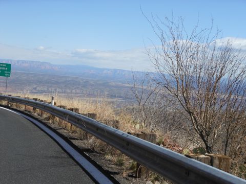 1995 Ford Bronco - A scenic overlook features a highway sign and a vast landscape with mountains in the distance.