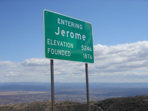 1995 Ford Bronco - Sign for Jerome, Arizona, with elevation and founding date visible against a cloudy sky.