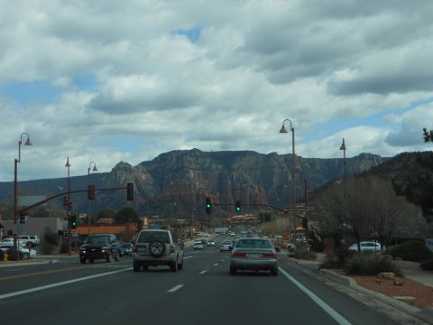 1995 Ford Bronco - A view from a vehicle driving on a highway with traffic and a scenic mountain range in the distance.