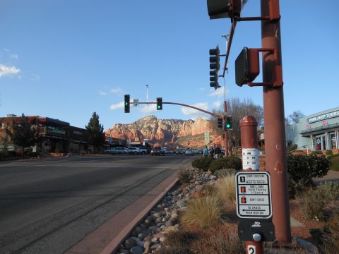 1995 Ford Bronco - Street view of Sedona, Arizona, with red rock formations and a commercial area under a clear blue sky.