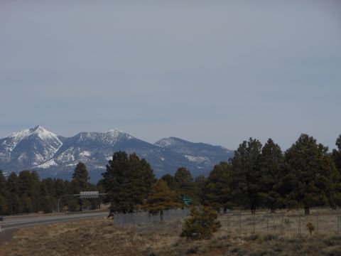 1995 Ford Bronco - Scenic view of mountains and trees along a highway, with a SUPERMOTORS watermark visible.