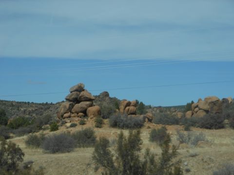 1995 Ford Bronco - Desert landscape with rock formations and power lines overhead. Supermotors.net logo visible.