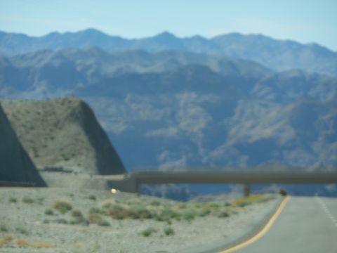 1995 Ford Bronco - View of a desert landscape with mountains and a highway overpass, captured on a clear day.