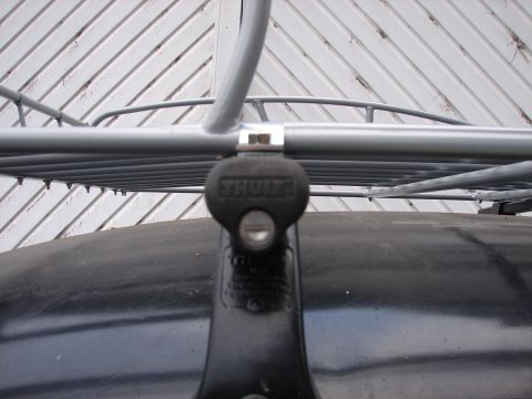 1964 Volkswagen Beetle - Close-up of a Thule roof rack mount attached to a dark vehicle surface.