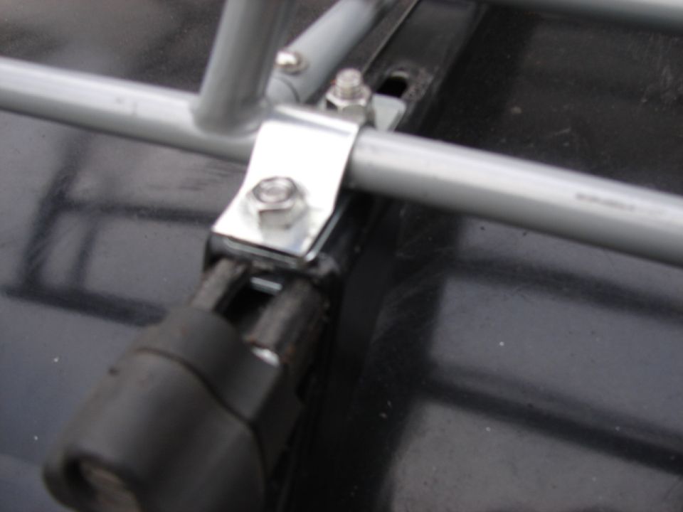 Roof rack mounting hardware on dark surface