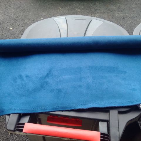 1978 Ford Bronco - Close-up of blue fabric and black plastic components, possibly from a vehicle interior.