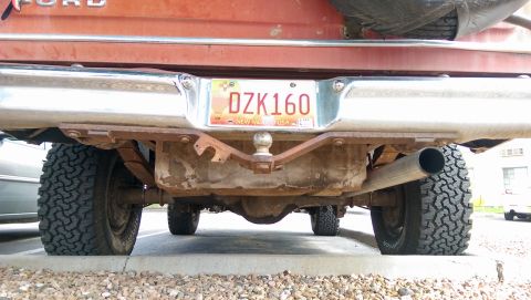 1978 Ford Bronco - This image shows the rear of a red Ford truck, including its hitch, exhaust, and tires.