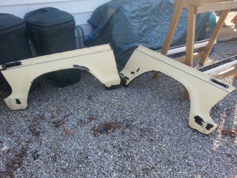 1989 Ford Ranger - These vehicle fenders are laid out on a gravel surface next to some trash cans and tarps.
