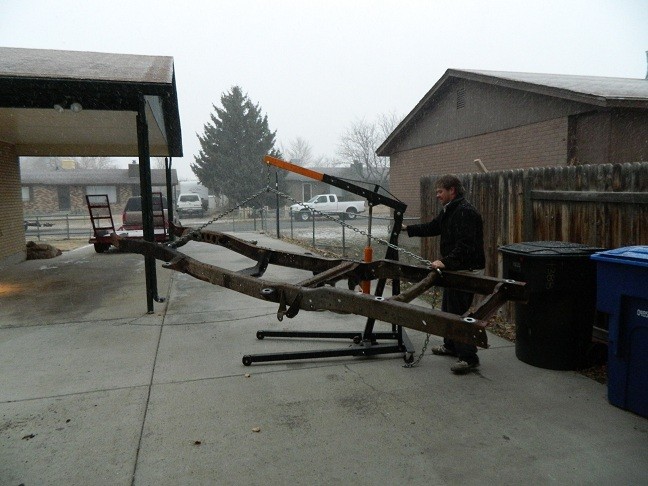 Vehicle frame on engine hoist during winter weather