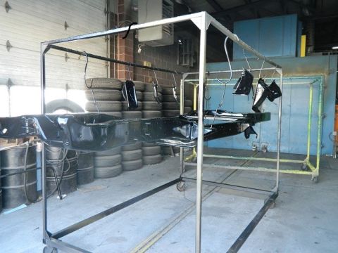 1979 Ford Bronco - Vehicle frame and parts undergoing powder coating in a workshop environment.