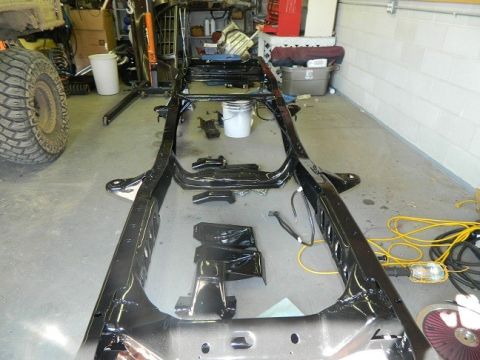 1979 Ford Bronco - Vehicle frame undergoing powder coating in a workshop setting.