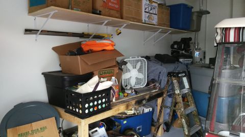 1994 Ford Bronco - A cluttered garage scene with various storage items and tools.