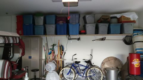 1994 Ford Bronco - A garage scene two bicycles, various storage bins, and cleaning supplies.