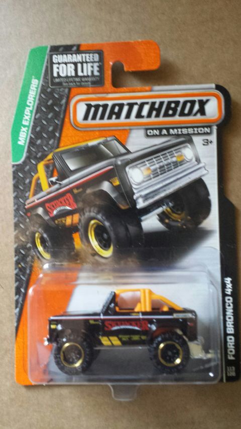 1982 Ford F-100 - Matchbox toy car packaging shows a black Ford Bronco 4x4 with yellow accents and racing stripes.