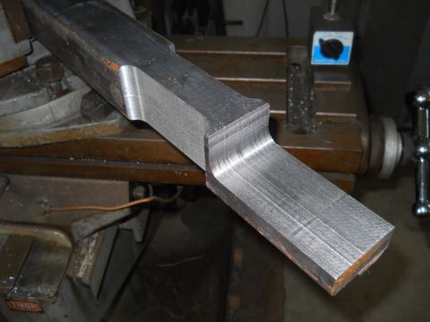 1992 Ford Bronco - Metal part being machined on a milling machine with a magnetic base indicator.
