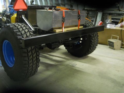 1992 Ford Bronco - Rear view of a modified truck chassis with a large fuel tank and off-road tires.