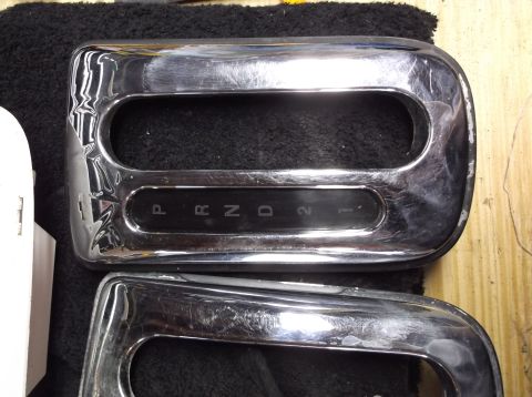 1999 Mercury Grand Marquis - Close-up of a chrome gear shifter trim piece, displaying the P, R, N, D, 2, and 1 indicators.