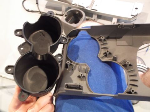 1999 Mercury Grand Marquis - A disassembled center console cup holder assembly is shown with a visible Supermotors.net logo.