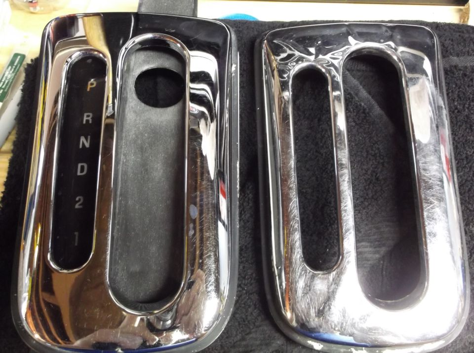 Two chrome gear shifter trim pieces, one with P, R, N, D, 2, 1 markings