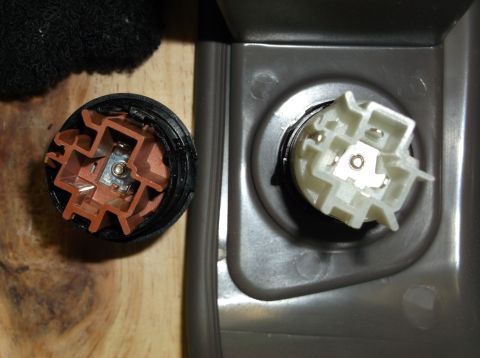 1999 Mercury Grand Marquis - Close-up of two automotive electrical connectors, one brown and one white, with visible metal contacts.