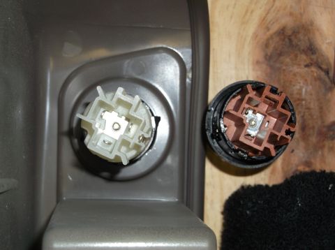 1999 Mercury Grand Marquis - Close-up of an interior electrical connector and its corresponding plug, likely for a console component.