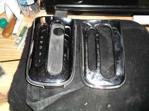 1999 Mercury Grand Marquis - Chrome gear shifter console with P R N D 2 1 indicators, next to a similar trim piece.