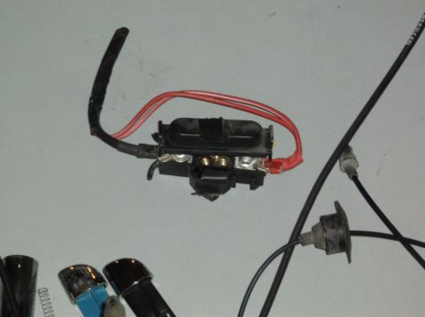 1999 Mercury Grand Marquis - A close-up view of an automotive electrical component, likely a fuse box, with visible wiring and connectors.