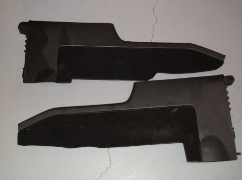 1999 Mercury Grand Marquis - Two black plastic console trim pieces, likely for a car's center console, are shown against a plain background.