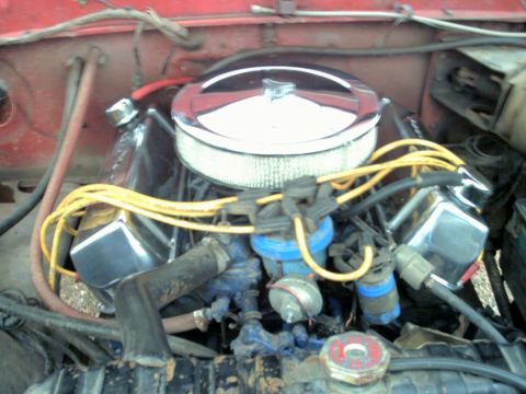 1978 Ford Bronco - Close-up of an engine bay, a chrome air cleaner and various engine components.