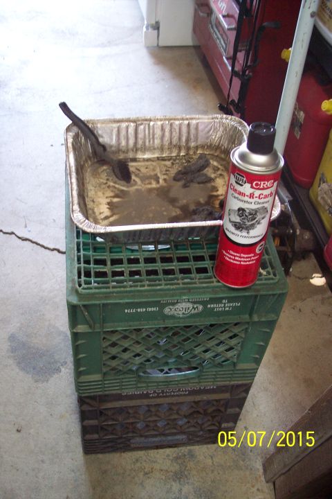 1973 Ford F-250 - Carburetor parts soaking in a pan with cleaning fluid and a can of CRC Clean-R-Carb.