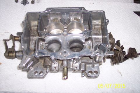 1973 Ford F-250 - Close-up of a carburetor, likely undergoing a rebuild or cleaning.