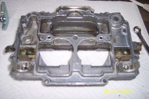 1973 Ford F-250 - This is a close-up view of a carburetor base, likely undergoing maintenance or rebuild.