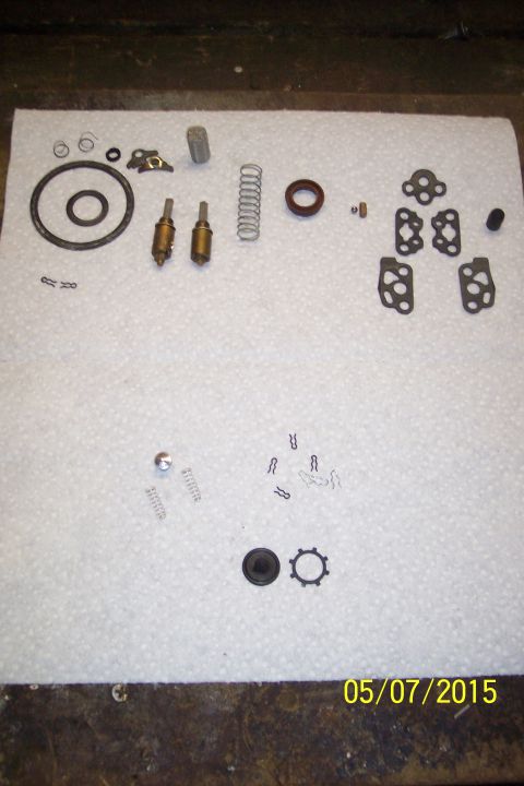 1973 Ford F-250 - Various small metal and rubber components are spread across a textured surface.