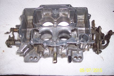 1973 Ford F-250 - A carburetor part is shown on a white surface, with a Supermotors.net watermark visible.