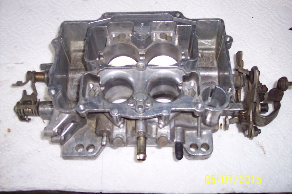 Carburetor part on white surface