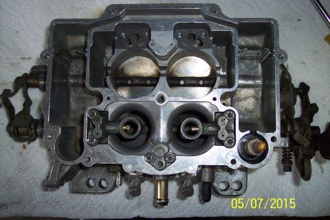 1973 Ford F-250 - Close-up view of a Holley carburetor, showing internal components and linkages.