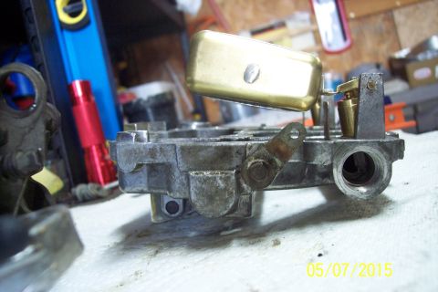 1973 Ford F-250 - Close-up of a carburetor assembly, possibly undergoing a rebuild or repair.