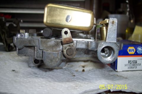 1973 Ford F-250 - Carburetor part with brass float and linkage, next to a NAPA RS1034 box.