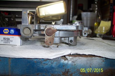 1973 Ford F-250 - A close-up view of a carburetor, with a NAPA part box in the background.
