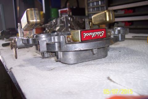 1973 Ford F-250 - A close-up view of an Edelbrock carburetor, likely undergoing a rebuild or maintenance.