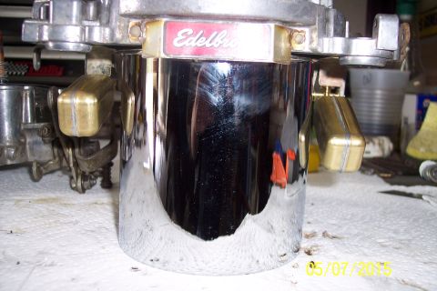 1973 Ford F-250 - Edelbrock carburetor part shown in detail, with visible brass floats and chrome finish.