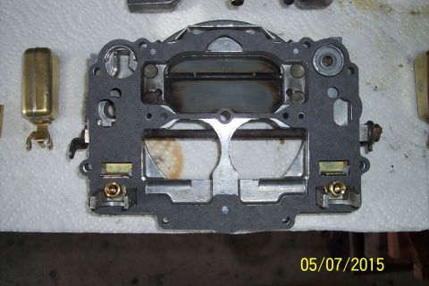1973 Ford F-250 - A carburetor gasket is shown with associated parts, suggesting a rebuild or maintenance process.