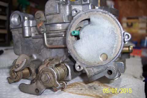 1973 Ford F-250 - Close-up of a carburetor, possibly for an older vehicle, with visible mechanical components.