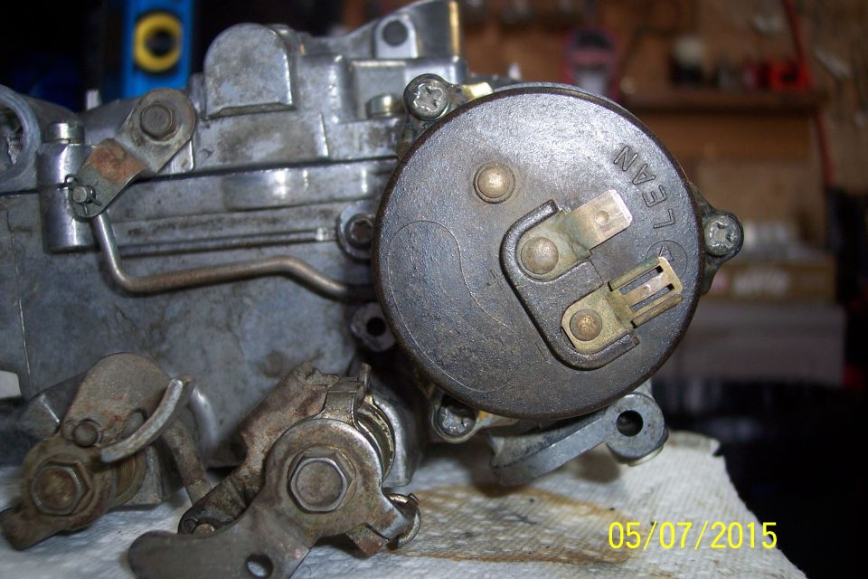 Close-up of a carburetor with "LEAN" visible on a cap