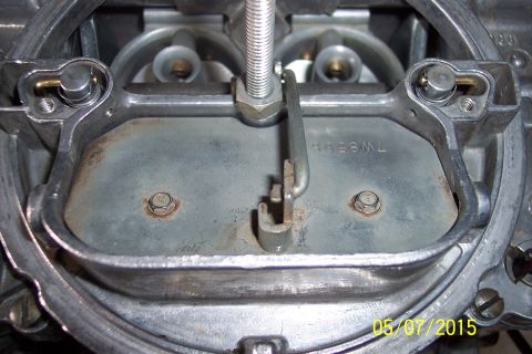 1973 Ford F-250 - A detailed view of a carburetor, showing internal components and a stamped part number.