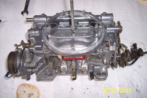 1973 Ford F-250 - An Edelbrock carburetor is shown on a white surface, possibly during a rebuild or maintenance process.